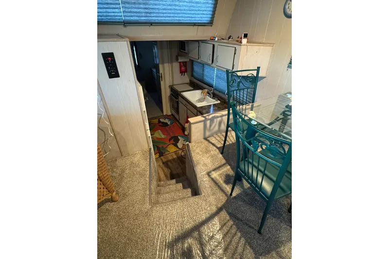 Slide: The Image of Interior of 1996 Gibson 50 Cabin Yacht with stairs, kitchen, and dining area. - 19