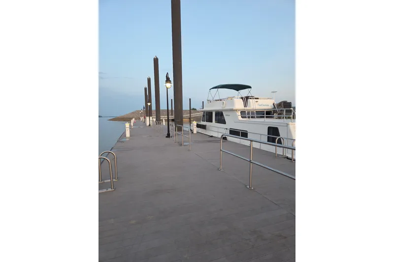 Slide: The Image of 1996 Gibson 50 Cabin Yacht docked at a marina under a clear sky. - 2