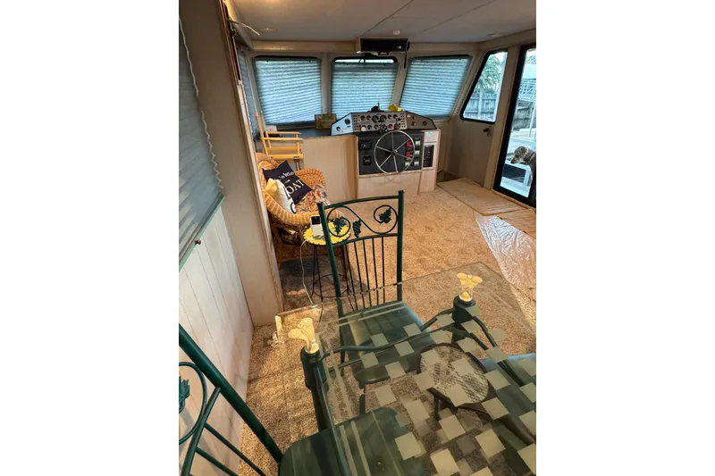 Slide: The Image of Interior of 1996 Gibson 50 Cabin Yacht with helm, seating, and glass table. - 20