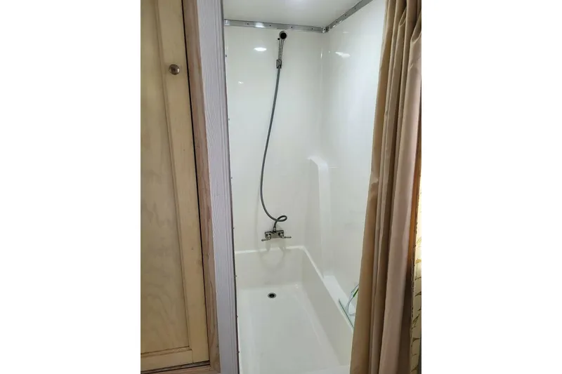 Slide: The Image of Shower area in 1996 Gibson 50 Cabin Yacht with curtain and handheld showerhead. - 23