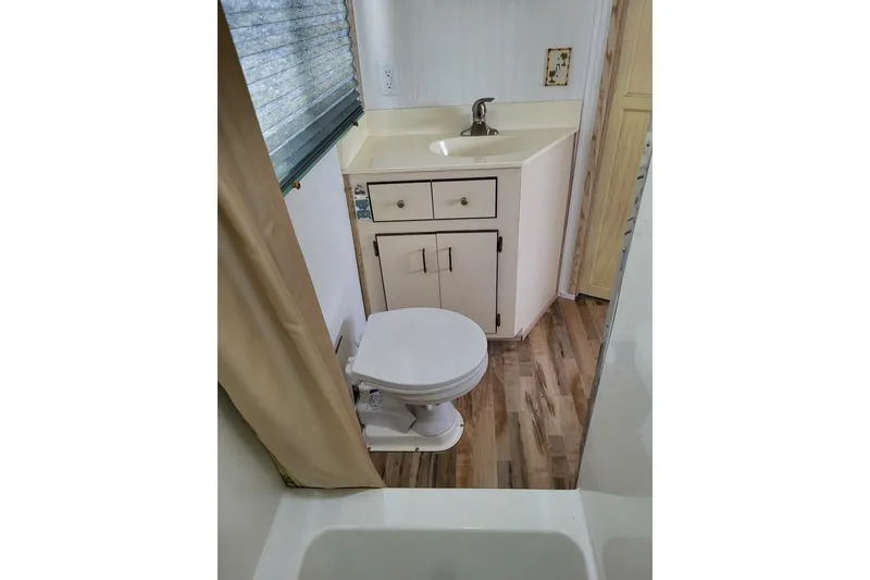 Slide: The Image of Bathroom interior of 1996 Gibson 50 Cabin Yacht with sink and toilet. - 24
