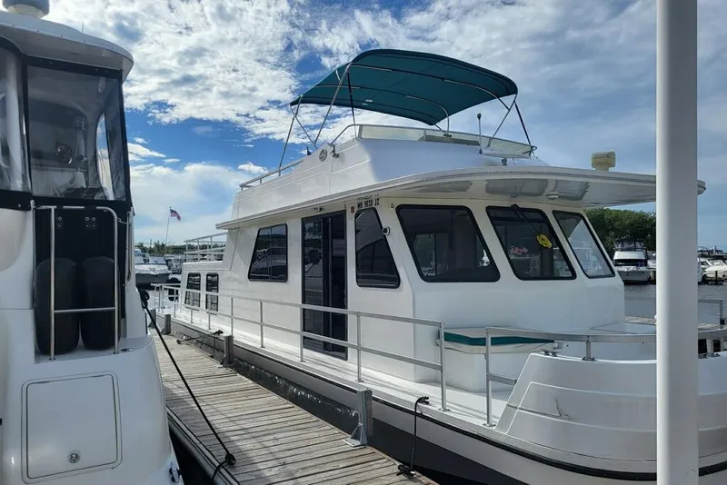 Slide: The Image of 1996 Gibson 50 Cabin Yacht docked under a blue sky. - 3