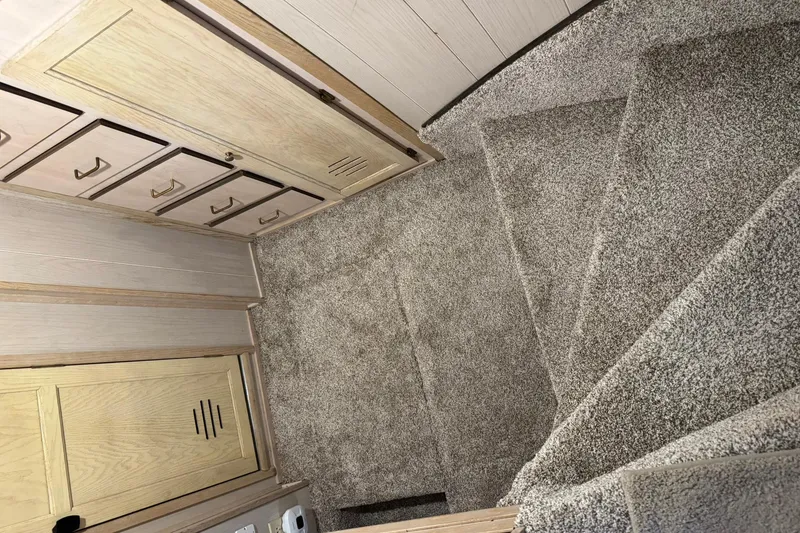 Slide: The Image of Carpeted stairs and wooden cabinets inside a 1996 Gibson 50 Cabin Yacht. - 30