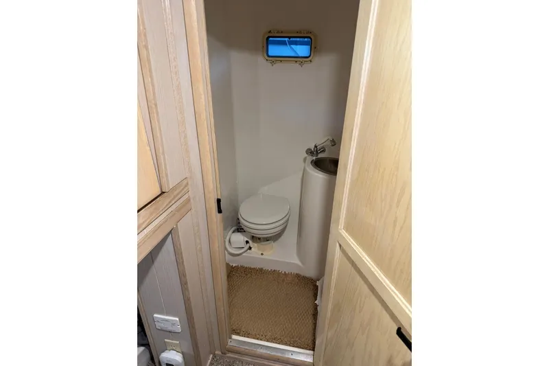 Slide: The Image of Bathroom interior of 1996 Gibson 50 Cabin Yacht with toilet and sink. - 31
