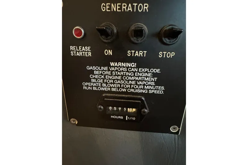 Slide: The Image of Generator control panel on 1996 Gibson 50 Cabin Yacht with safety warning and hour meter. - 37