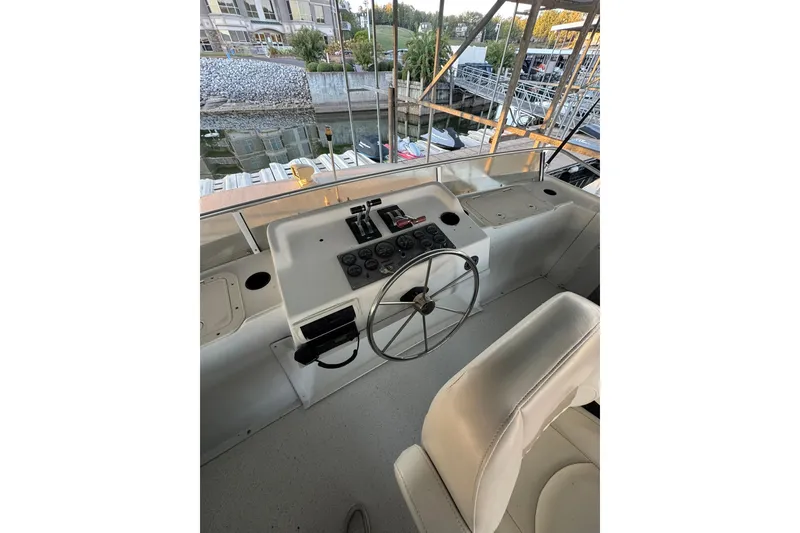 Slide: The Image of 1996 Gibson 50 Cabin Yacht helm with steering wheel and control panel. - 6