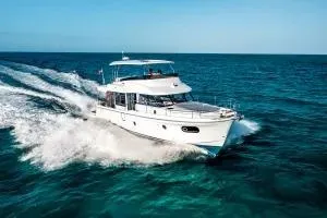 Slide: The Image of 2026 Beneteau Swift Trawler 48 cruising on open sea, showcasing sleek design and performance. - 2