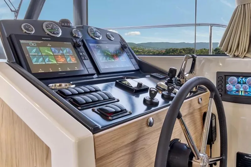 Slide: The Image of Helm of 2026 Beneteau Swift Trawler 48 with advanced navigation displays and controls. - 6