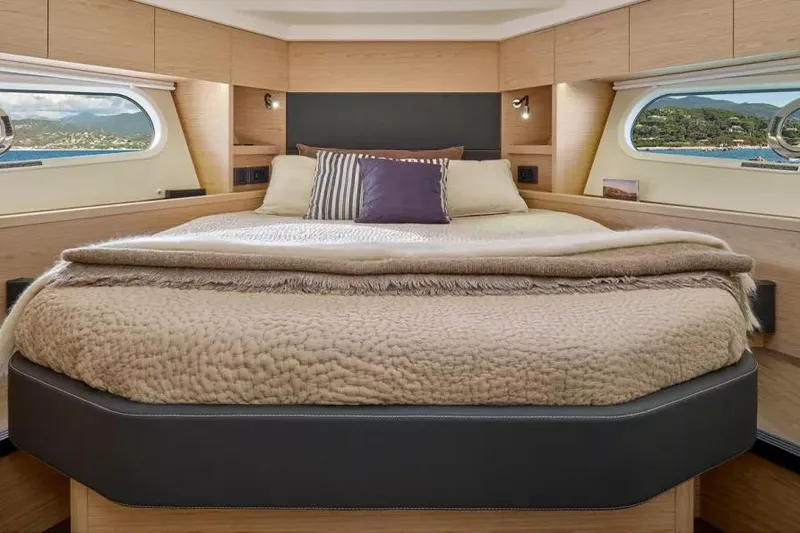Slide: The Image of Luxurious bedroom interior of 2026 Beneteau Swift Trawler 48 with scenic window views. - 8