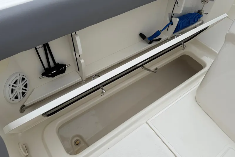 Slide: The Image of 2024 Boston Whaler 250 Outrage covered at marina, surrounded by luxury boats. - 22