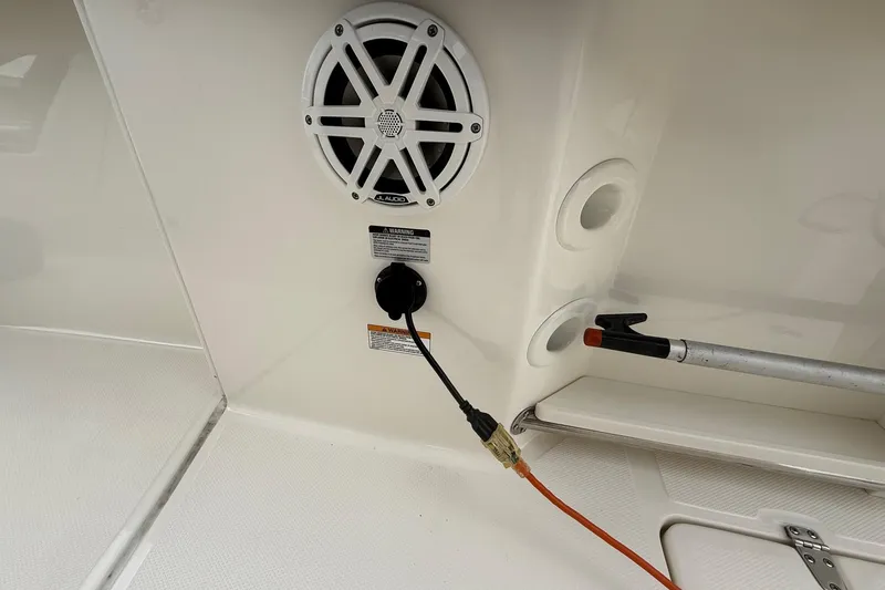 Slide: The Image of 2024 Boston Whaler 250 Outrage covered at marina, featuring twin Mercury engines. - 23