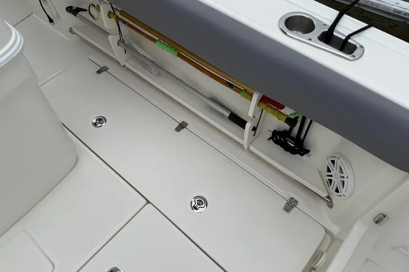 Slide: The Image of 2024 Boston Whaler 250 Outrage covered at marina, featuring dual Mercury outboard engines. - 24