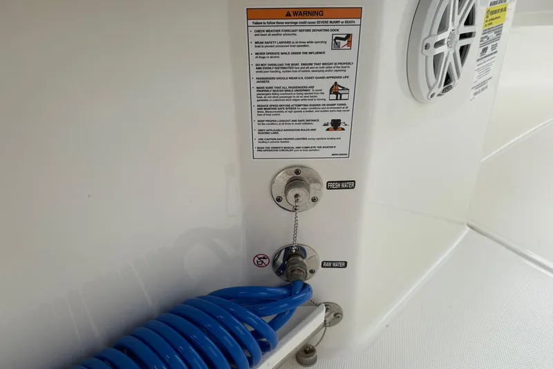 Slide: The Image of 2024 Boston Whaler 250 Outrage with twin Mercury V6 engines at a marina. - 26