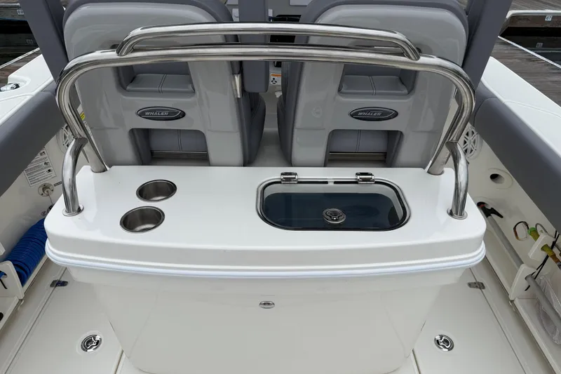 Slide: The Image of 2024 Boston Whaler 250 Outrage livewell with secure latch and clear lid. - 27