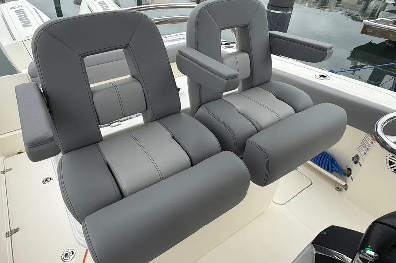 Slide: The Image of 2024 Boston Whaler 250 Outrage boat deck with seating and storage compartments. - 28