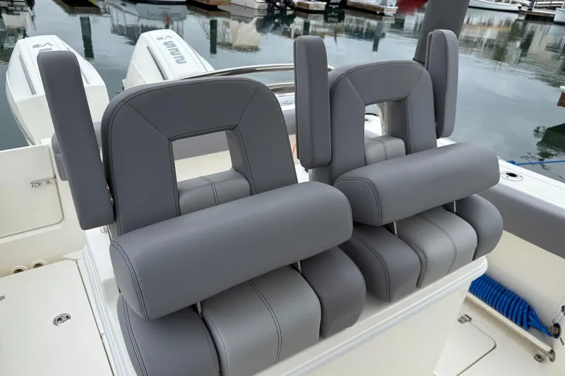 Slide: The Image of 2024 Boston Whaler 250 Outrage boat seat with gray upholstery and sleek design. - 29