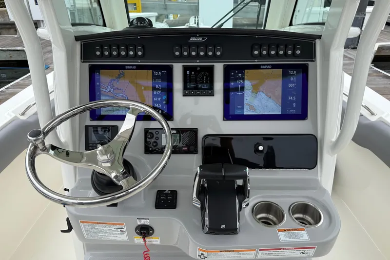 Slide: The Image of 2024 Boston Whaler 250 Outrage deck with storage compartments and marine speaker. - 31