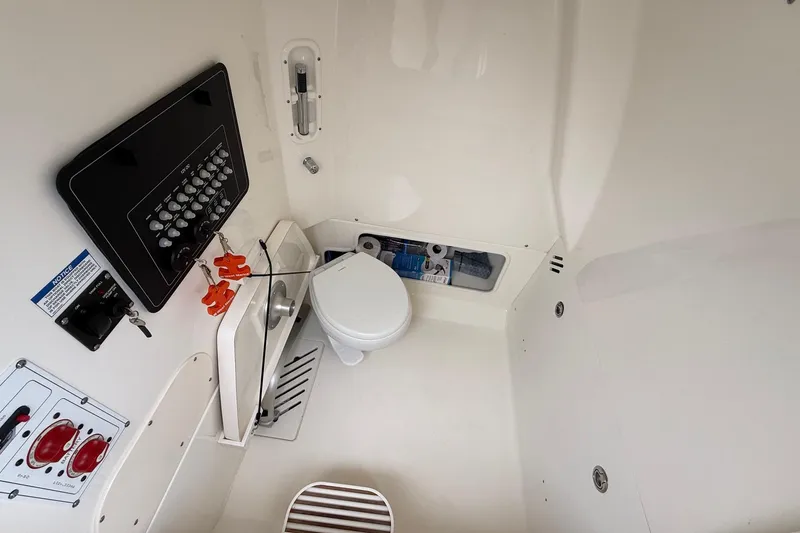 Slide: The Image of 2024 Boston Whaler 250 Outrage boat interior with rod storage and speaker. - 34