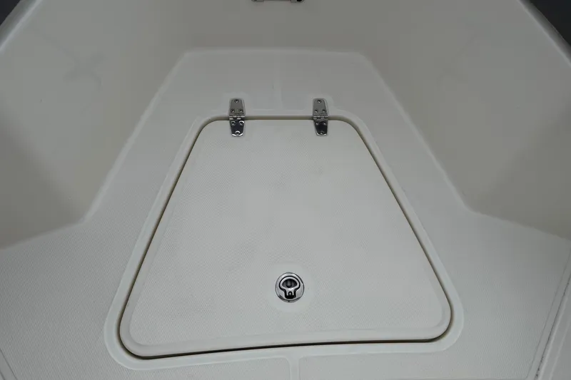 Slide: The Image of 2024 Boston Whaler 250 Outrage interior with toilet and control panel. - 44