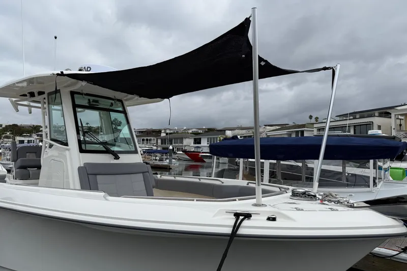 Slide: The Image of 2024 Boston Whaler 250 Outrage seat with storage compartment open. - 48