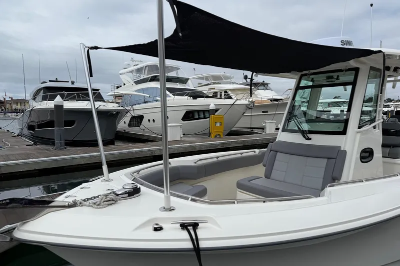 Slide: The Image of 2024 Boston Whaler 250 Outrage boat interior with gray cushioned seating. - 49