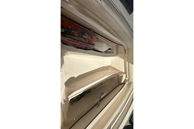 Slide: The Image of 2023 Grady-White Fisherman 257 storage compartment with life jackets and equipment. - 15