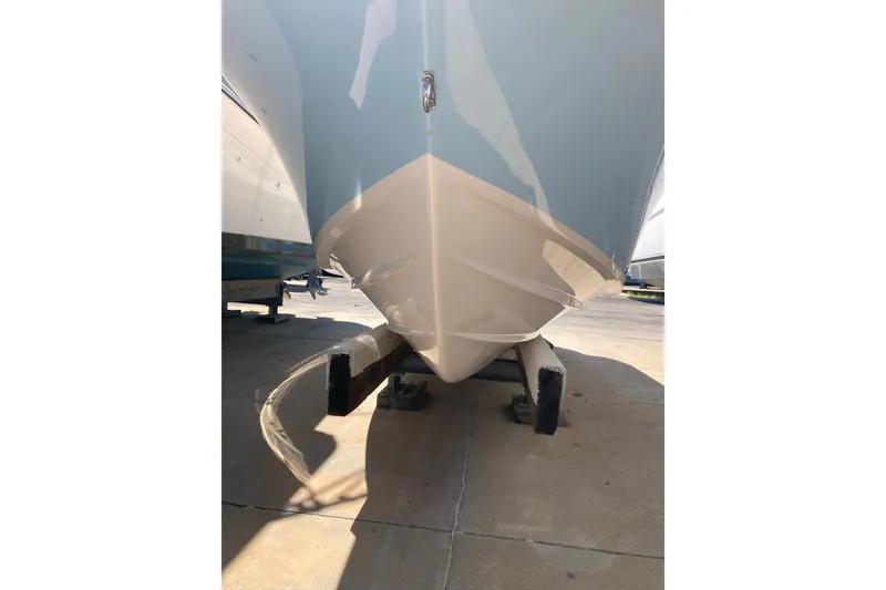 Slide: The Image of 2023 Grady-White Fisherman 257 boat hull on display in a marina. - 4