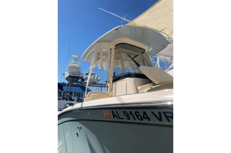 Slide: The Image of 2023 Grady-White Fisherman 257 boat docked under clear blue sky. - 7