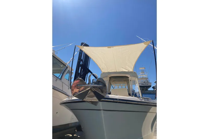 Slide: The Image of 2023 Grady-White Fisherman 257 boat with sunshade, docked under clear blue sky. - 8