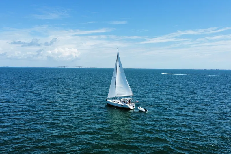 Slide: The Image of Sailboat Hunter 38 (2005) cruising on open sea under clear blue sky. - 2