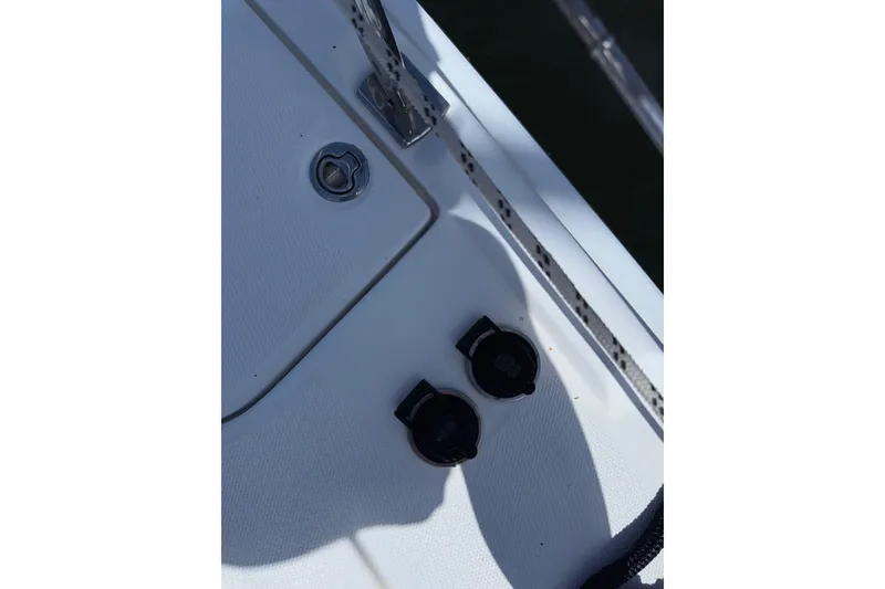Slide: The Image of Deck fittings on a 2005 Hunter 38 sailboat, featuring cleats and rope details. - 22