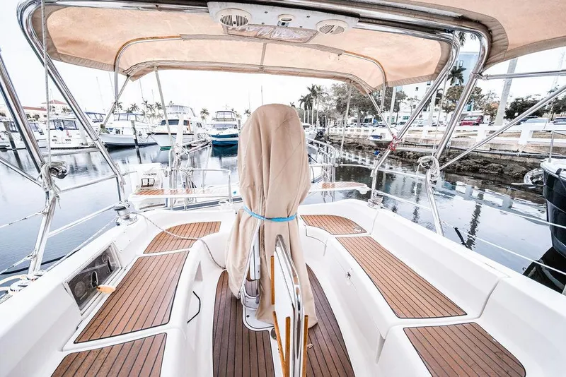 Slide: The Image of 2005 Hunter 38 sailboat cockpit with teak flooring, docked at a marina. - 27