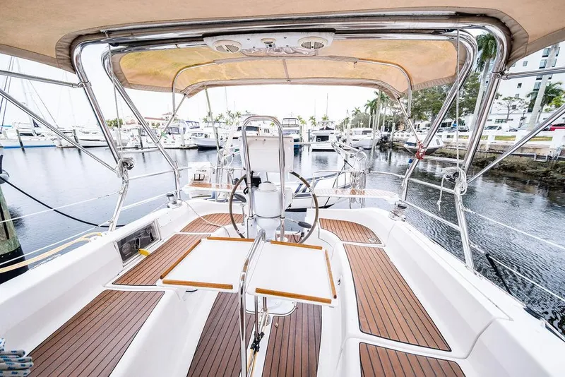 Slide: The Image of 2005 Hunter 38 sailboat cockpit with teak flooring and dual steering wheels at marina. - 28