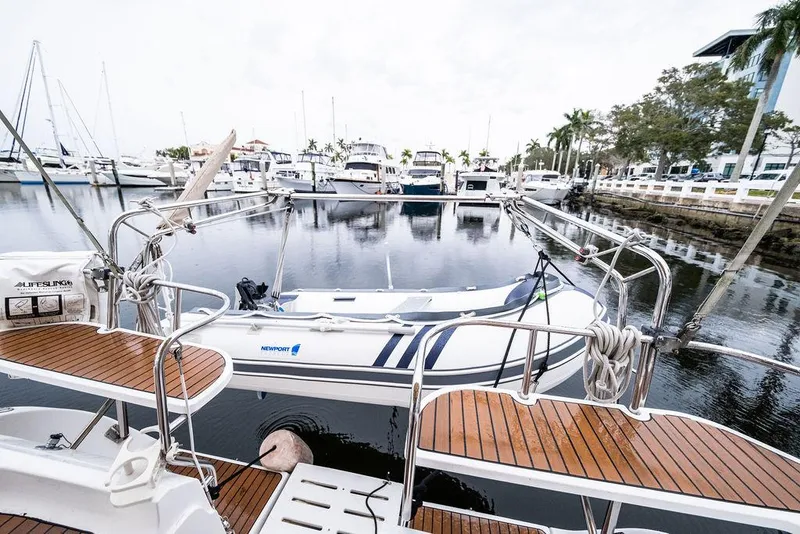 Slide: The Image of Hunter 38 sailboat from 2005 docked at a marina with wooden deck details. - 29