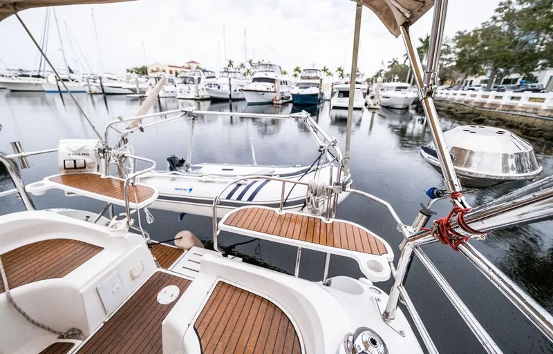 Slide: The Image of Hunter 38 sailboat, 2005 model, docked in a marina with wooden deck and nautical equipment. - 30