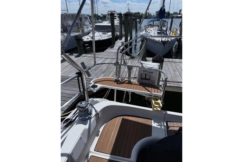 Slide: The Image of Hunter 38 sailboat docked, showcasing deck and marina view, 2005 model. - 31