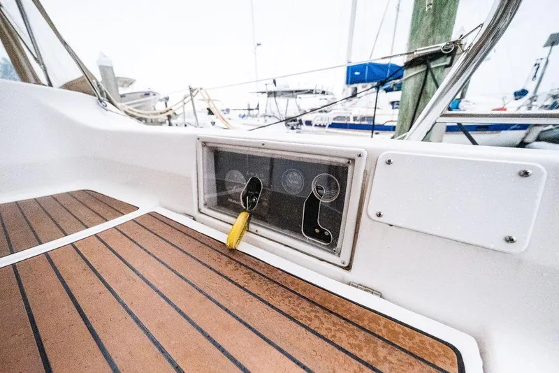 Slide: The Image of Cockpit view of a 2005 Hunter 38 sailboat with teak flooring and control panel. - 32
