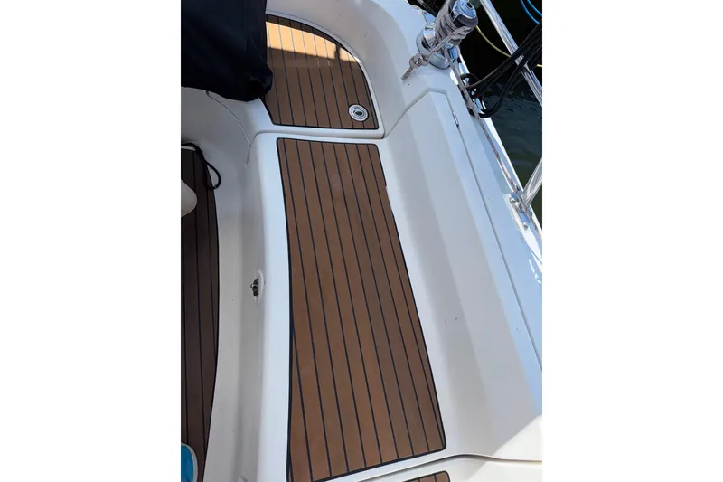 Slide: The Image of Hunter 38 sailboat deck, 2005 model, featuring teak-style flooring and stainless steel fittings. - 34