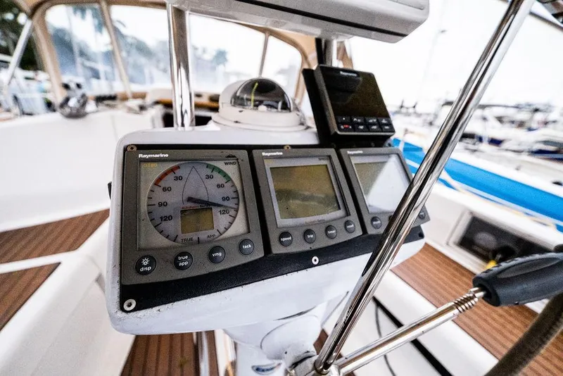 Slide: The Image of Cockpit instruments of a 2005 Hunter 38 sailboat, featuring navigation displays and controls. - 39