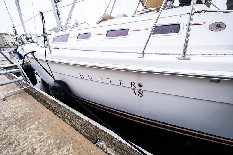 Slide: The Image of 2005 Hunter 38 sailboat docked at marina, side view. - 4