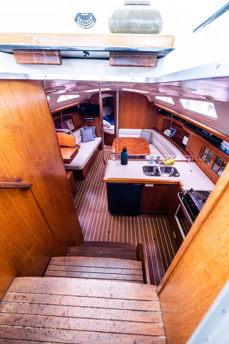 Slide: The Image of Interior of 2005 Hunter 38 sailboat with wooden finishes and compact kitchen area. - 41