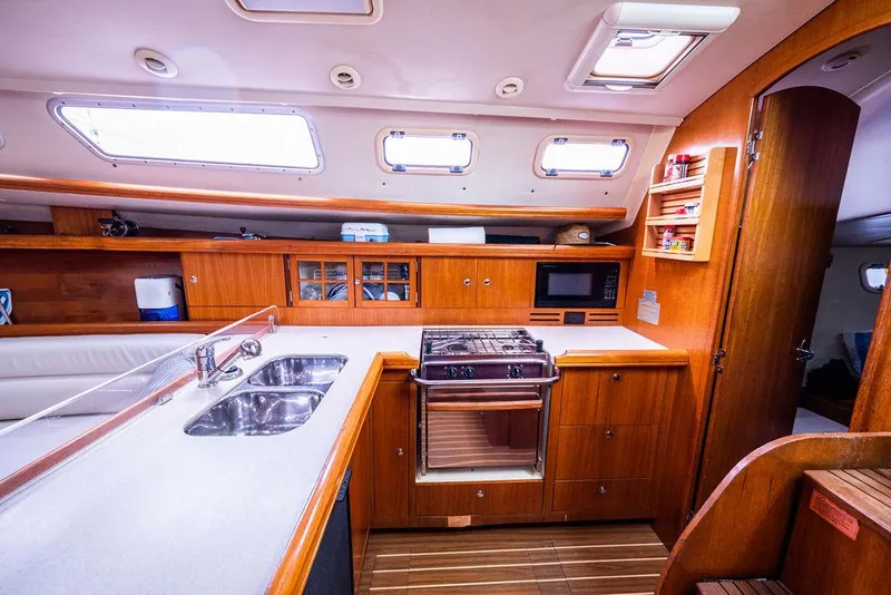 Slide: The Image of Interior of 2005 Hunter 38 yacht kitchen with wooden cabinetry and modern appliances. - 45