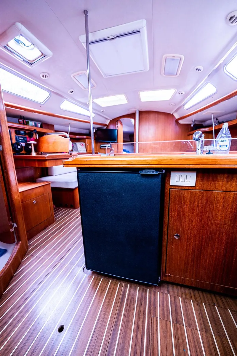 Slide: The Image of Interior of 2005 Hunter 38 sailboat with wood finish and compact kitchen area. - 47