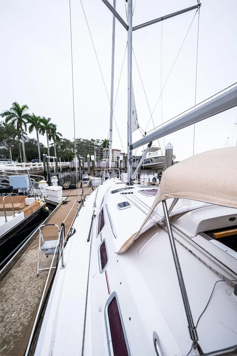 Slide: The Image of 2005 Hunter 38 sailboat docked at marina with palm trees in background. - 5