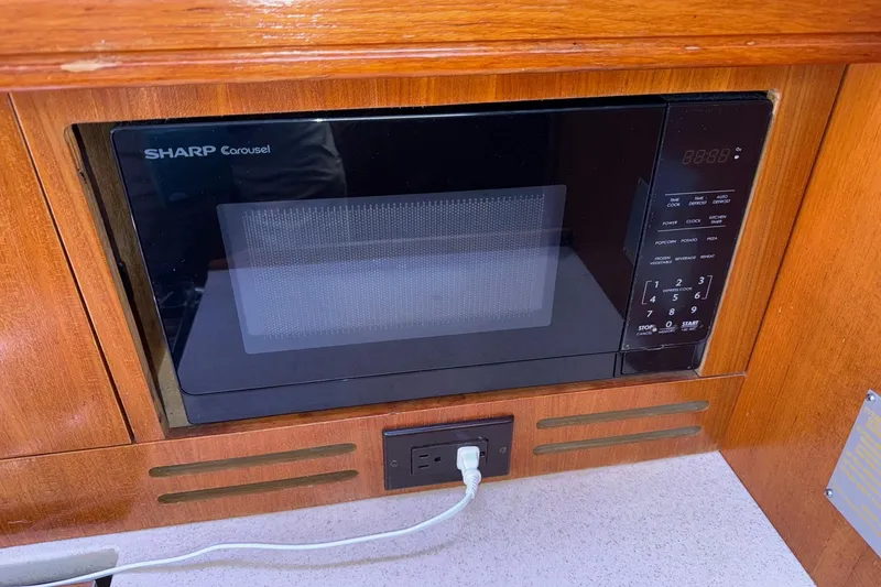 Slide: The Image of Sharp Carousel microwave in a 2005 Hunter 38 yacht's wooden interior. - 50