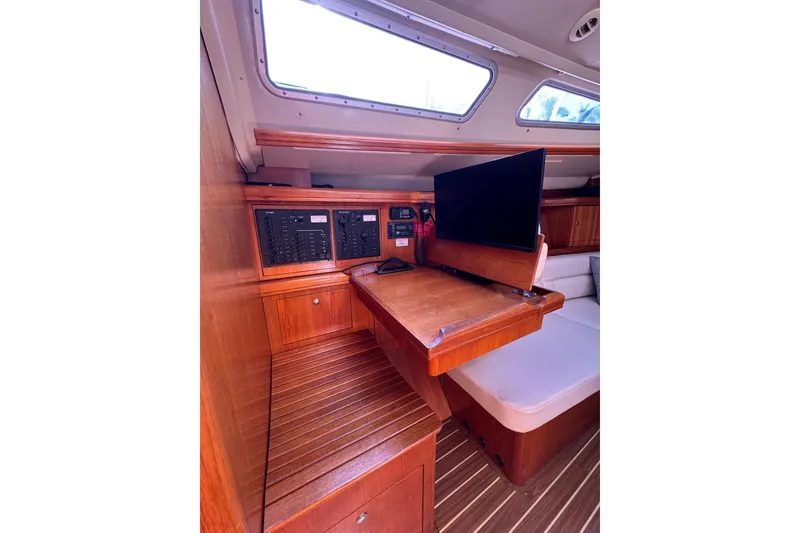Slide: The Image of Interior of 2005 Hunter 38 sailboat with navigation station and wooden cabinetry. - 51