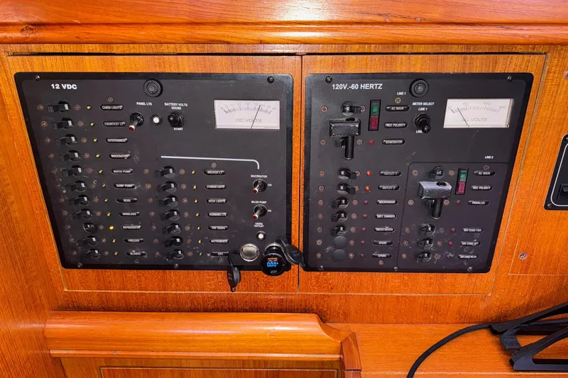 Slide: The Image of Electrical control panel on a 2005 Hunter 38 boat, featuring 12V and 120V systems. - 53