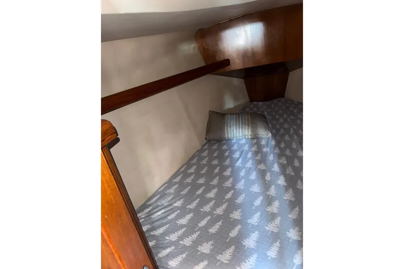 Slide: The Image of Cozy cabin bed in 2005 Hunter 38 sailboat with patterned bedding and pillow. - 57