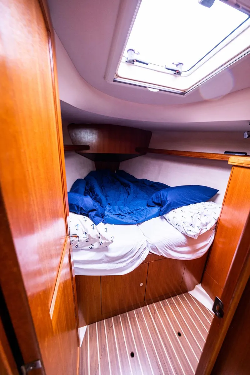 Slide: The Image of Cozy cabin interior of 2005 Hunter 38 sailboat with wooden finish and skylight. - 58
