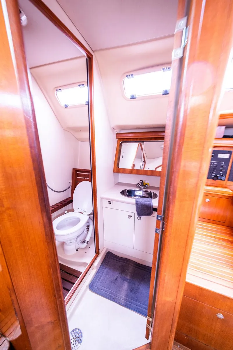 Slide: The Image of 2005 Hunter 38 yacht bathroom with wooden cabinetry and modern fixtures. - 60